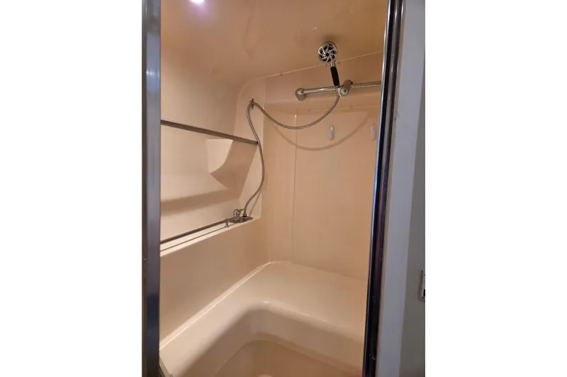Slide: The Image of Shower area inside 1997 Carver 350 Mariner boat, featuring a handheld showerhead. - 37