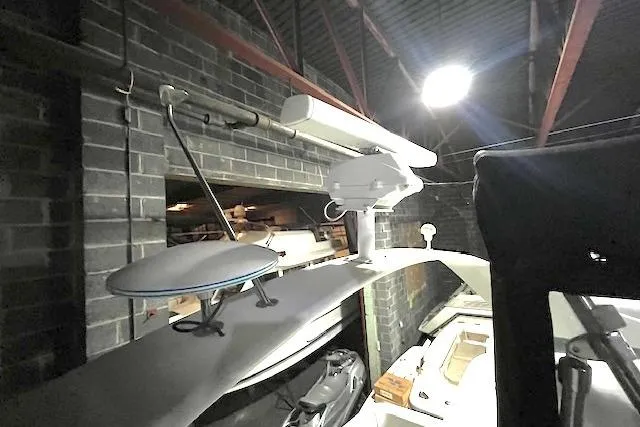 Slide: The Image of 1997 Carver 350 Mariner in storage, featuring radar and satellite equipment. - 44