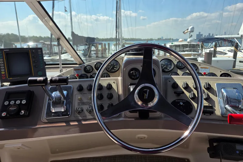 Slide: The Image of Cockpit of 1997 Carver 350 Mariner yacht with steering wheel and control panel. - 5