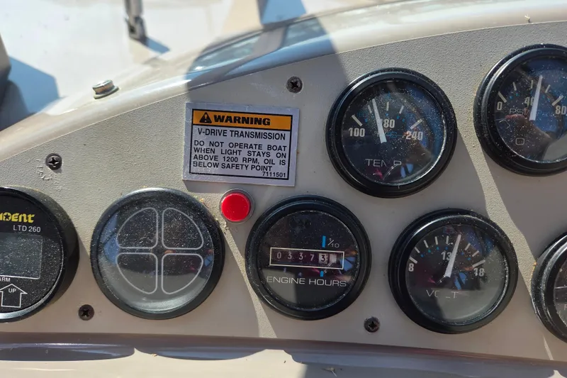 Slide: The Image of 1997 Carver 350 Mariner dashboard with gauges and warning label. - 7