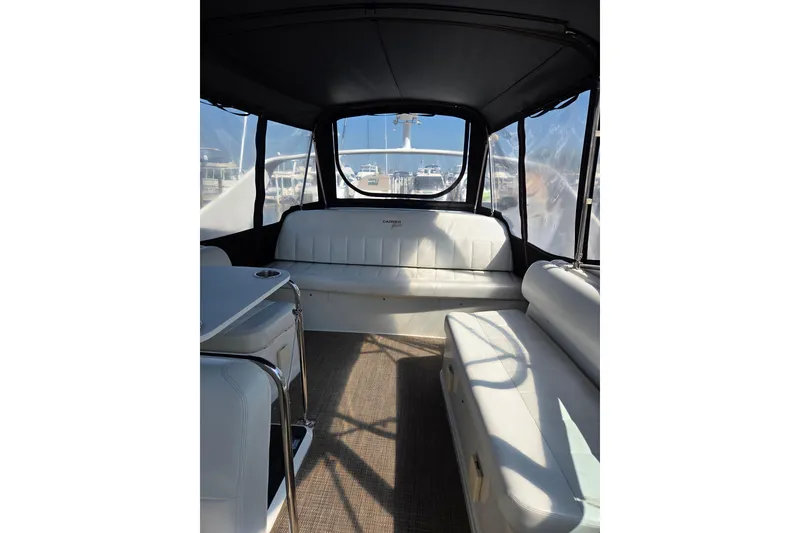 Slide: The Image of Interior of 1997 Carver 350 Mariner yacht with white seating and clear windows. - 19