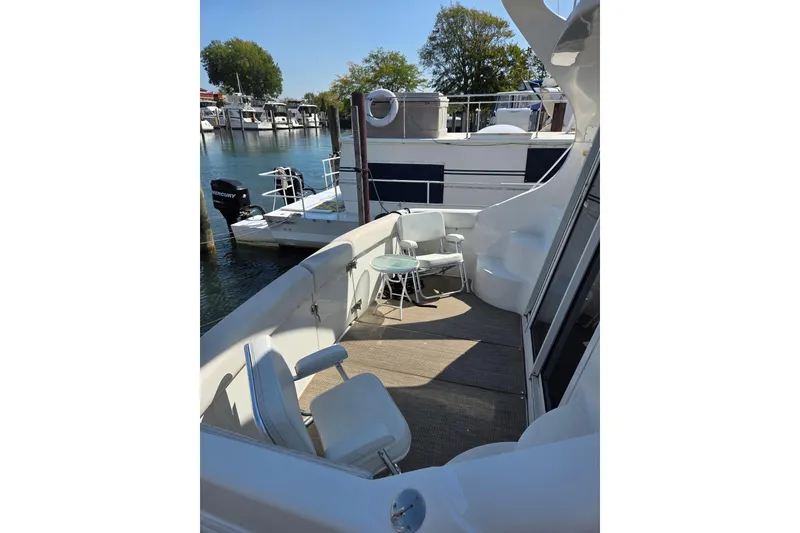 Slide: The Image of 1997 Carver 350 Mariner yacht deck with seating area, docked at marina. - 22