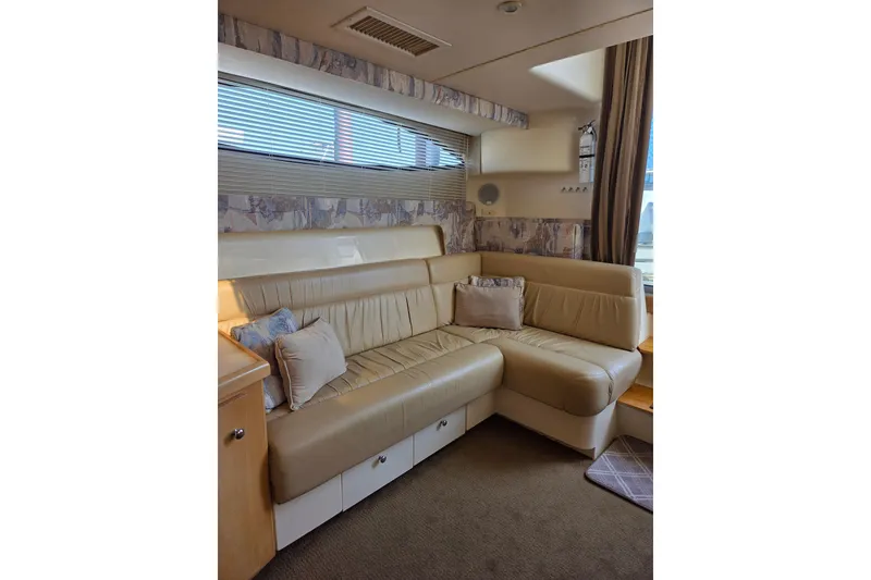 Slide: The Image of Interior of 1997 Carver 350 Mariner yacht with beige leather seating and decorative pillows. - 28