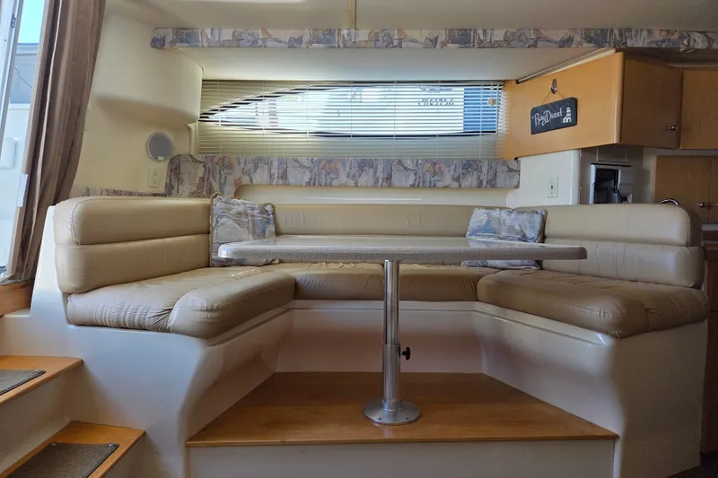 Slide: The Image of 1997 Carver 350 Mariner interior with beige seating and dining table. - 29