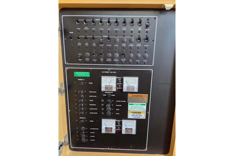 Slide: The Image of Electrical control panel of a 1997 Carver 350 Mariner boat with switches and meters. - 38