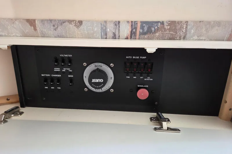 Slide: The Image of Control panel of a 1997 Carver 350 Mariner boat, featuring switches and gauges. - 39