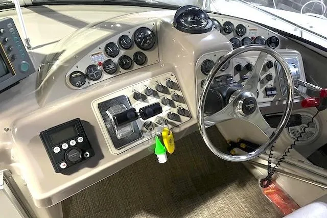 Slide: The Image of 1997 Carver 350 Mariner helm with steering wheel, gauges, and control panel. - 4