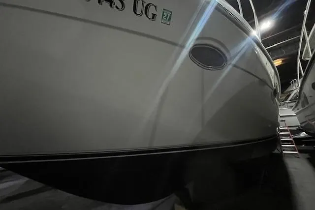Slide: The Image of 1997 Carver 350 Mariner boat hull in dimly lit storage area. - 42