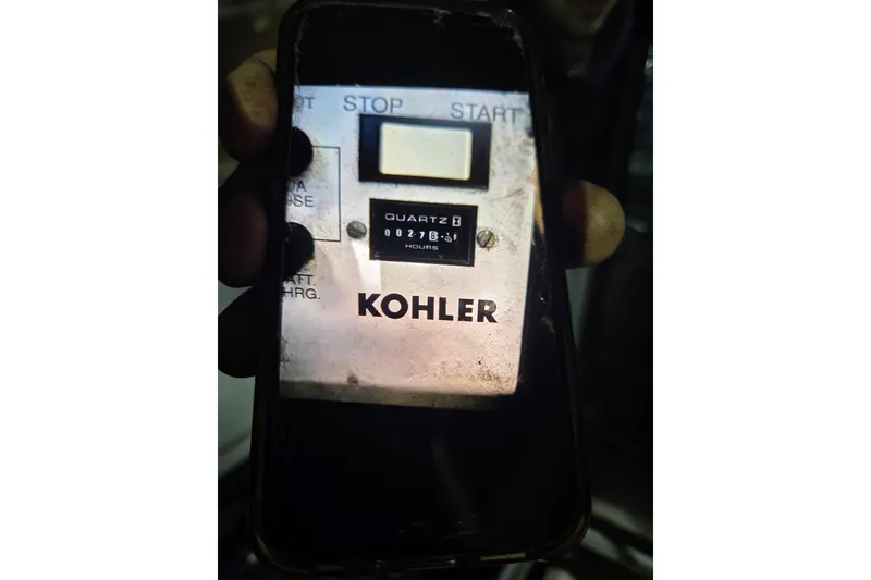 Slide: The Image of Close-up of a Kohler generator hour meter on a 1997 Carver 350 Mariner. - 46