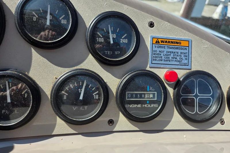 Slide: The Image of 1997 Carver 350 Mariner dashboard with gauges and warning label. - 6