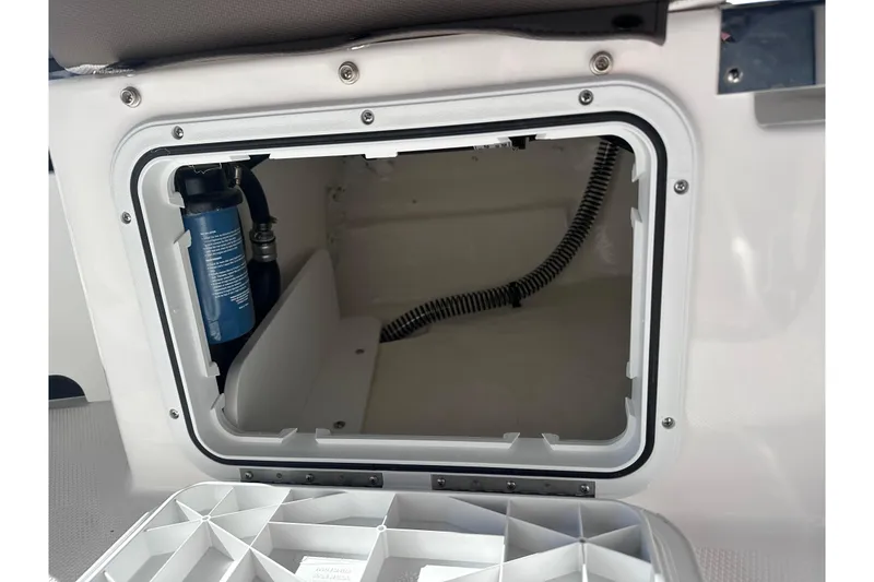 Slide: The Image of Open storage compartment in 2026 Edgewater 170CC boat, showcasing interior details and components. - 11