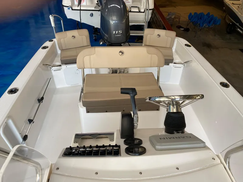 Slide: The Image of 2024 Edgewater 170CC Center Console boat interior with Garmin controls and Yamaha 115 engine. - 12