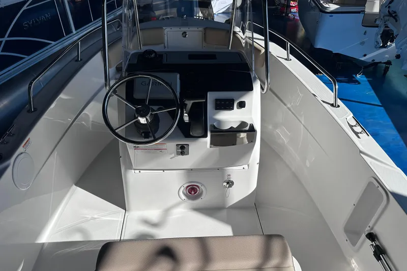Slide: The Image of Interior view of 2026 Edgewater 170CC boat, featuring steering wheel and control panel. - 16