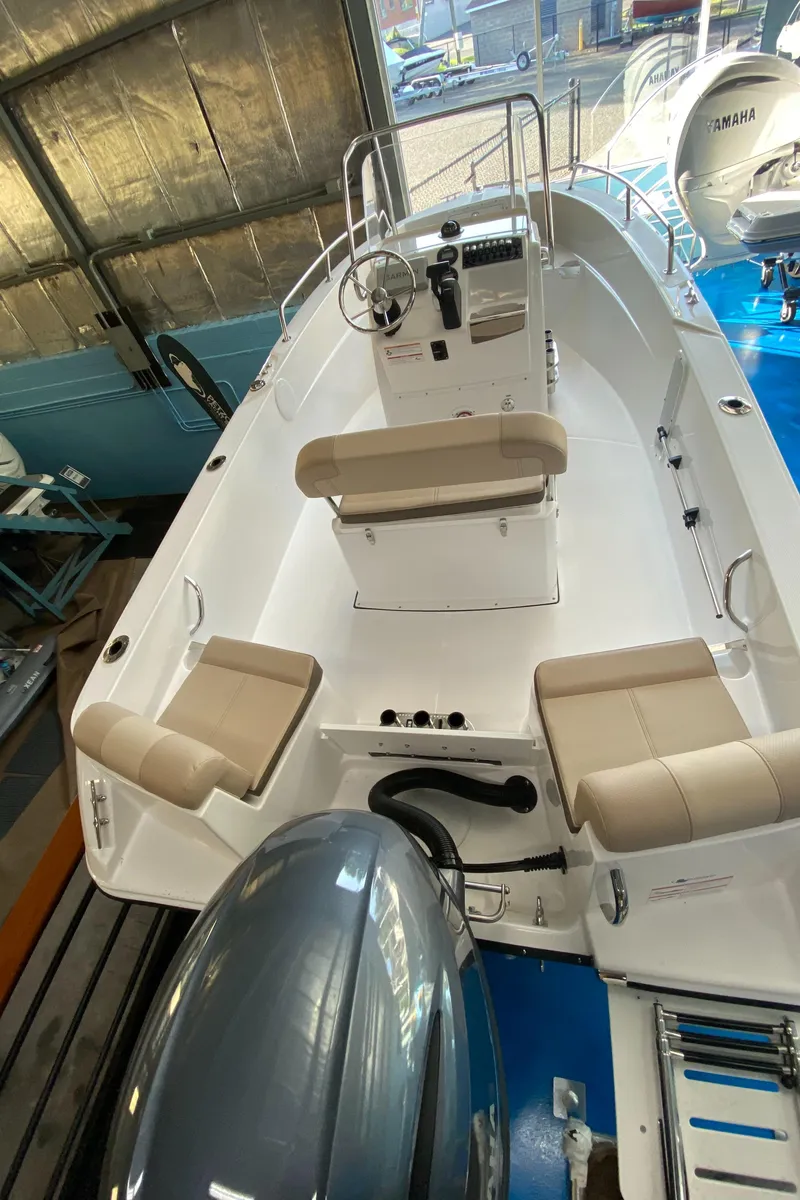 Slide: The Image of 2024 Edgewater 170CC Center Console boat displayed indoors. - 2