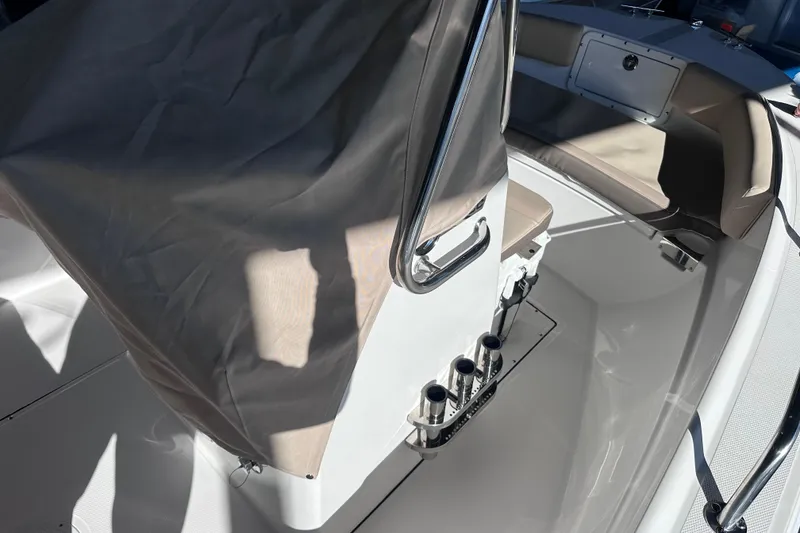 Slide: The Image of 2026 Edgewater 170CC boat interior with covered console and seating area. - 27