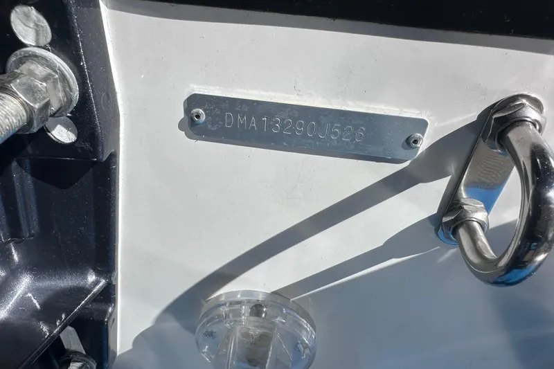 Slide: The Image of Hull identification number on 2026 Edgewater 170CC boat, featuring metal plate and hardware. - 28