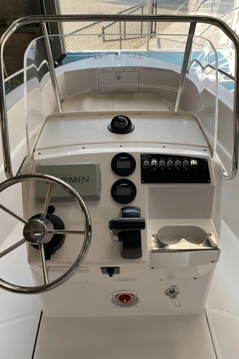 Slide: The Image of 2024 Edgewater 170CC Center Console boat with Yamaha outboard motor in a showroom. - 3