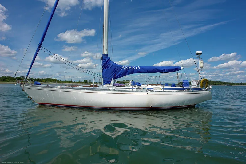 Slide: The Image of 1973 Nautor Swan 44 sailboat on calm water under a blue sky. - 10