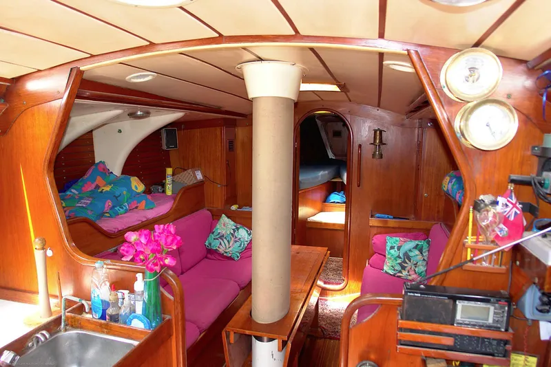 Slide: The Image of Interior of 1973 Nautor Swan 44 yacht with vibrant pink seating and wooden finishes. - 12