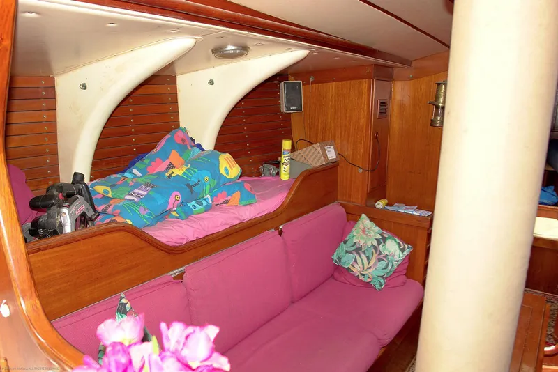 Slide: The Image of Interior of 1973 Nautor Swan 44 yacht with pink seating and colorful bedding. - 13