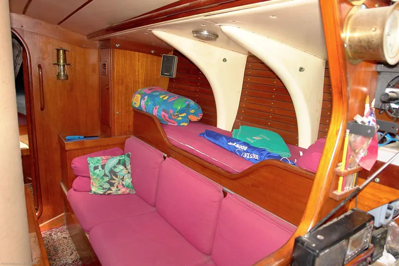 Slide: The Image of Interior of 1973 Nautor Swan 44 sailboat with pink seating and wooden paneling. - 14