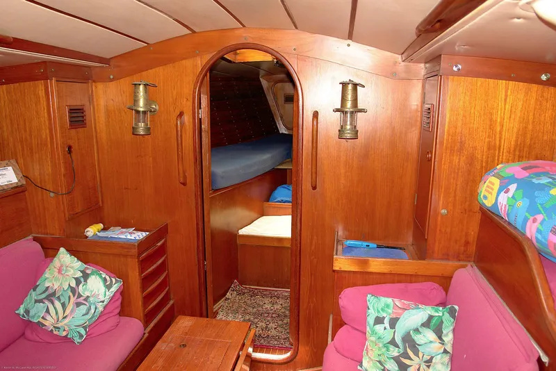 Slide: The Image of Interior of 1973 Nautor Swan 44 yacht with wooden finish and cozy seating area. - 17