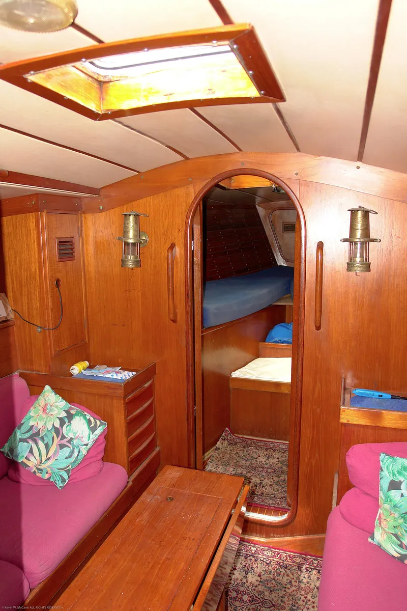 Slide: The Image of Interior of 1973 Nautor Swan 44 yacht with wooden paneling and cozy seating. - 18