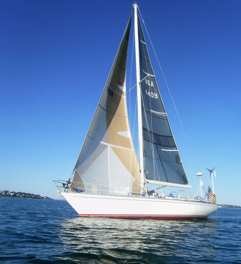Slide: The Image of 1973 Nautor Swan 44 sailboat on calm water under clear blue sky. - 2