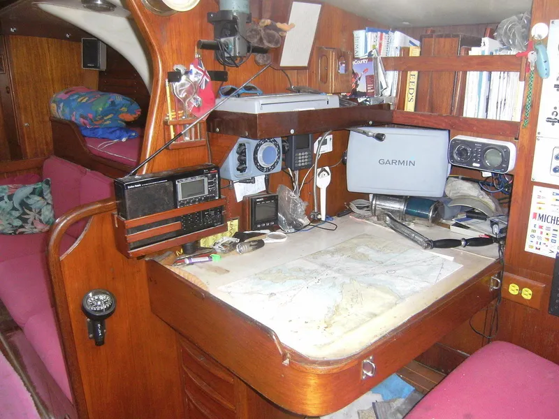 Slide: The Image of Navigation station inside a 1973 Nautor Swan 44 yacht, featuring maps and electronic equipment. - 20