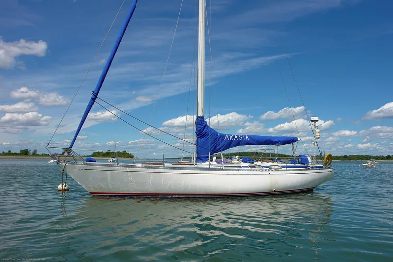 Slide: The Image of Sailing yacht Nautor Swan 44, 1973 model, anchored on calm water under a clear blue sky. - 27