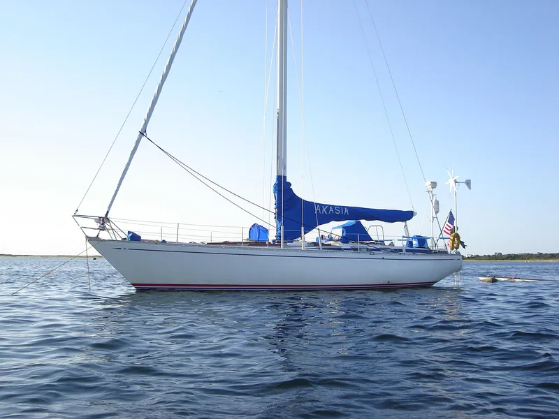 Slide: The Image of 1973 Nautor Swan 44 sailboat on calm water, featuring blue sail cover. - 29