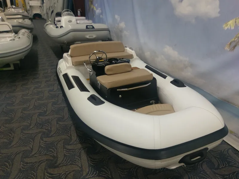 Slide: The Image of 2023 Ribjet 10 inflatable boat with beige seating in showroom. - 7