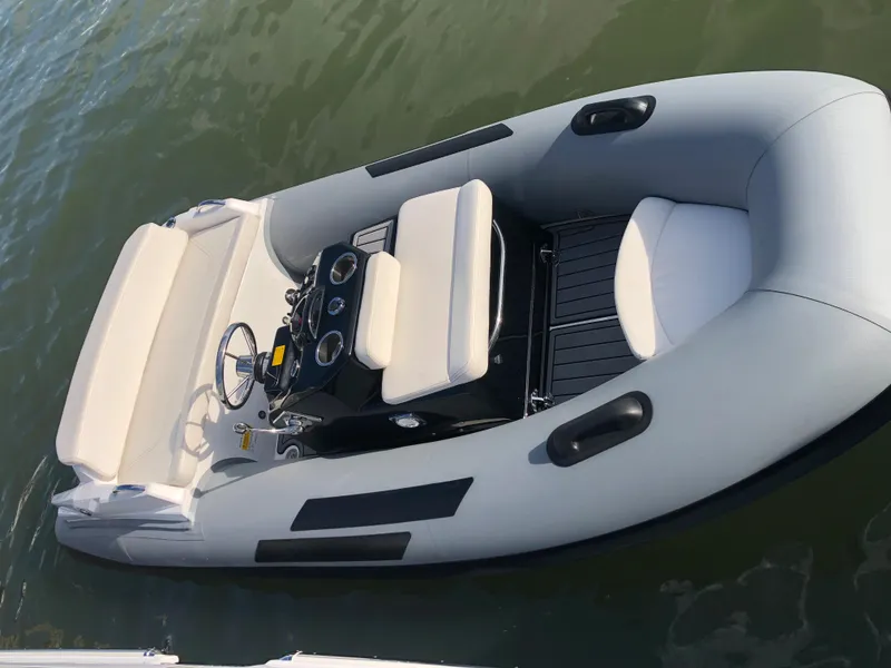 Slide: The Image of 2023 Ribjet 10 inflatable boat on water, featuring a sleek design and comfortable seating. - 8