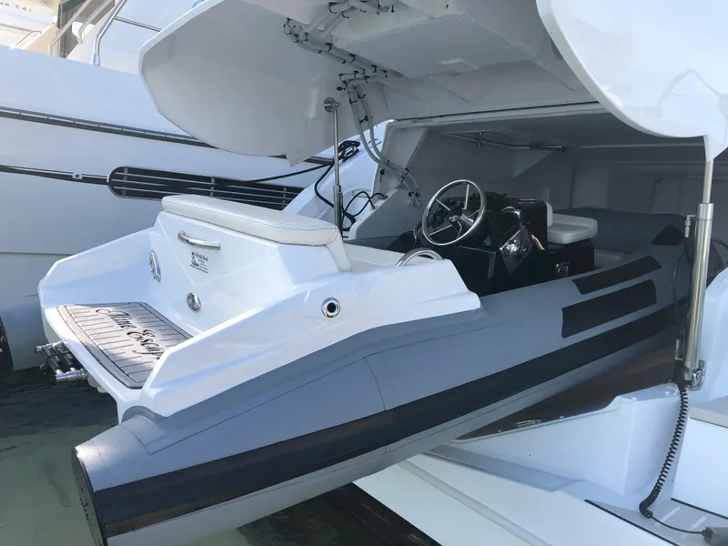 Slide: The Image of 2023 Ribjet 10 model boat docked with open storage compartment. - 9