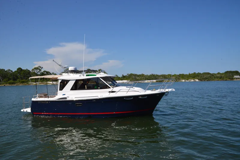 Slide: The Image of 2016 Cutwater C26 boat on calm water under clear blue sky. - 1