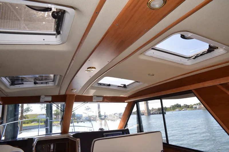 Slide: The Image of Interior view of 2016 Cutwater C26 boat with skylights and water view. - 11