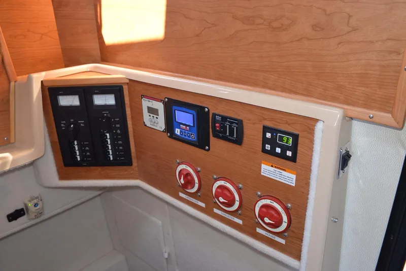 Slide: The Image of Control panel of a 2016 Cutwater C26 boat with switches and gauges. - 15
