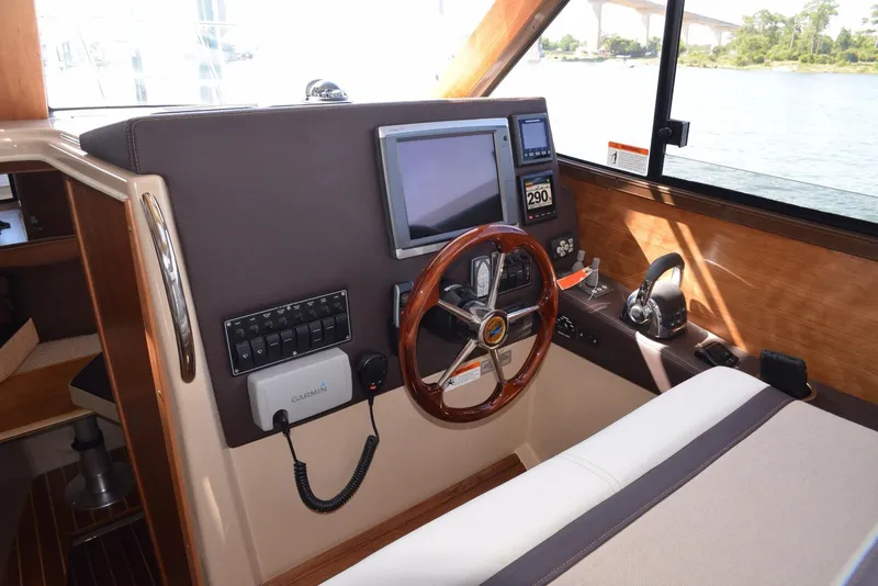 Slide: The Image of 2016 Cutwater C26 helm with steering wheel, navigation screen, and control panel. - 2