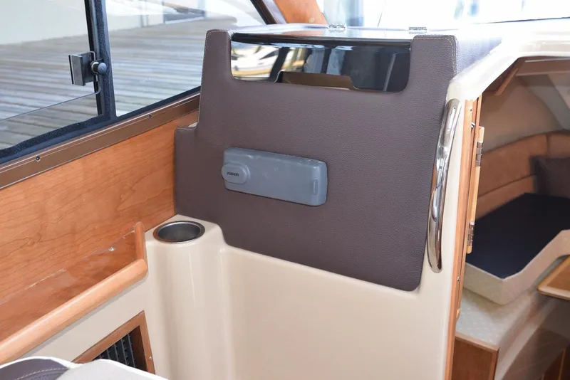 Slide: The Image of Interior view of a 2016 Cutwater C26 boat, featuring wood and leather accents. - 3