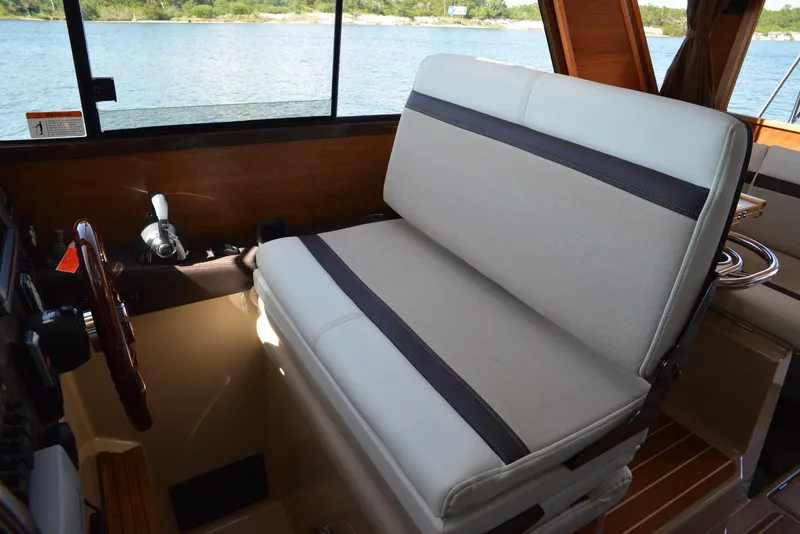 Slide: The Image of Interior of 2016 Cutwater C26 boat with cushioned seating and wooden accents. - 5