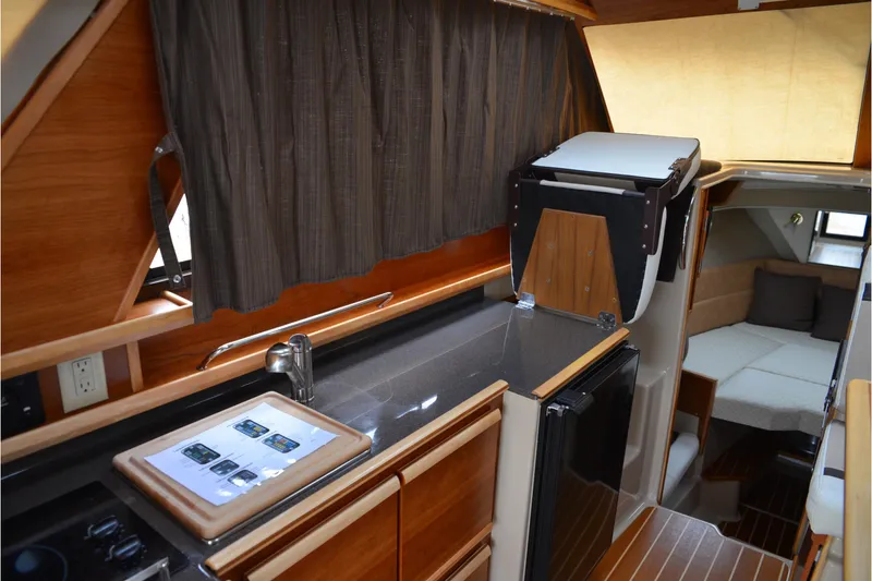 Slide: The Image of 2016 Cutwater C26 interior with modern kitchen and cozy cabin space. - 6