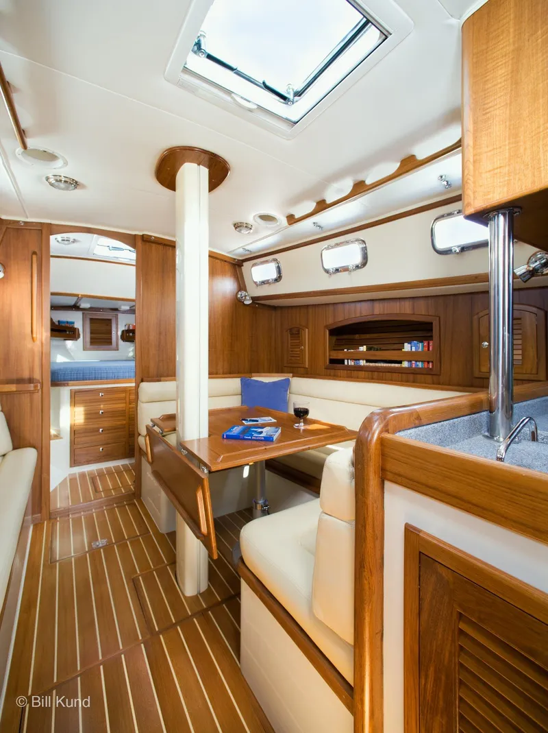Slide: The Image of Interior of 2025 Pacific Seacraft 40 yacht, featuring elegant wood finish and cozy seating area. - 17