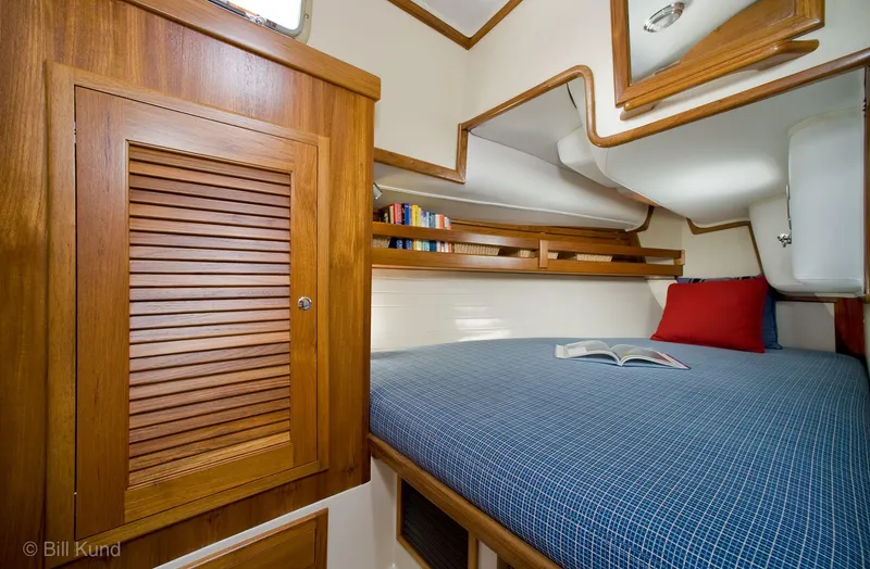 Slide: The Image of Cozy cabin interior of 2025 Pacific Seacraft 40 yacht with wooden accents and comfortable bedding. - 18