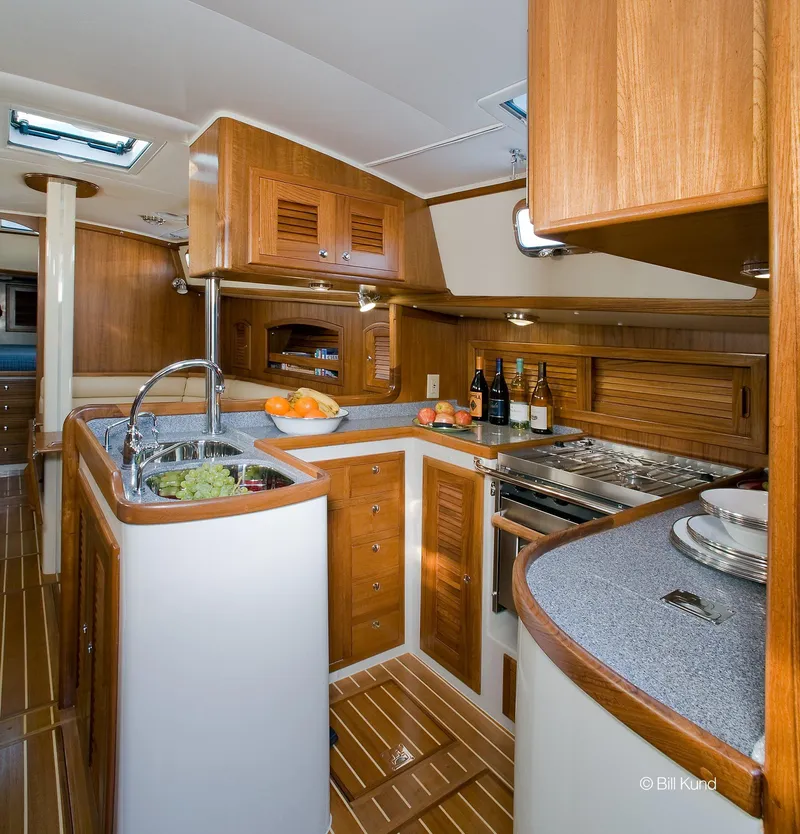 Slide: The Image of Luxurious 2025 Pacific Seacraft 40 yacht interior with modern kitchen and wooden cabinetry. - 20