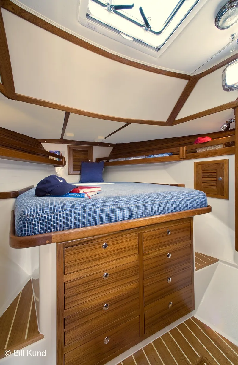 Slide: The Image of Interior of 2025 Pacific Seacraft 40 sailboat, featuring a cozy cabin with wooden cabinetry. - 21
