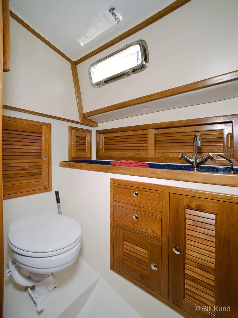 Slide: The Image of 2025 Pacific Seacraft 40 yacht bathroom with wooden cabinets and modern fixtures. - 22