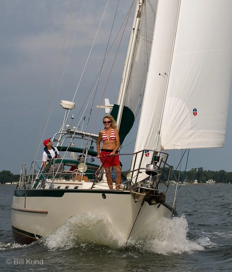 Slide: The Image of 2025 Pacific Seacraft 40 sailboat navigating through water with two people on deck. - 6