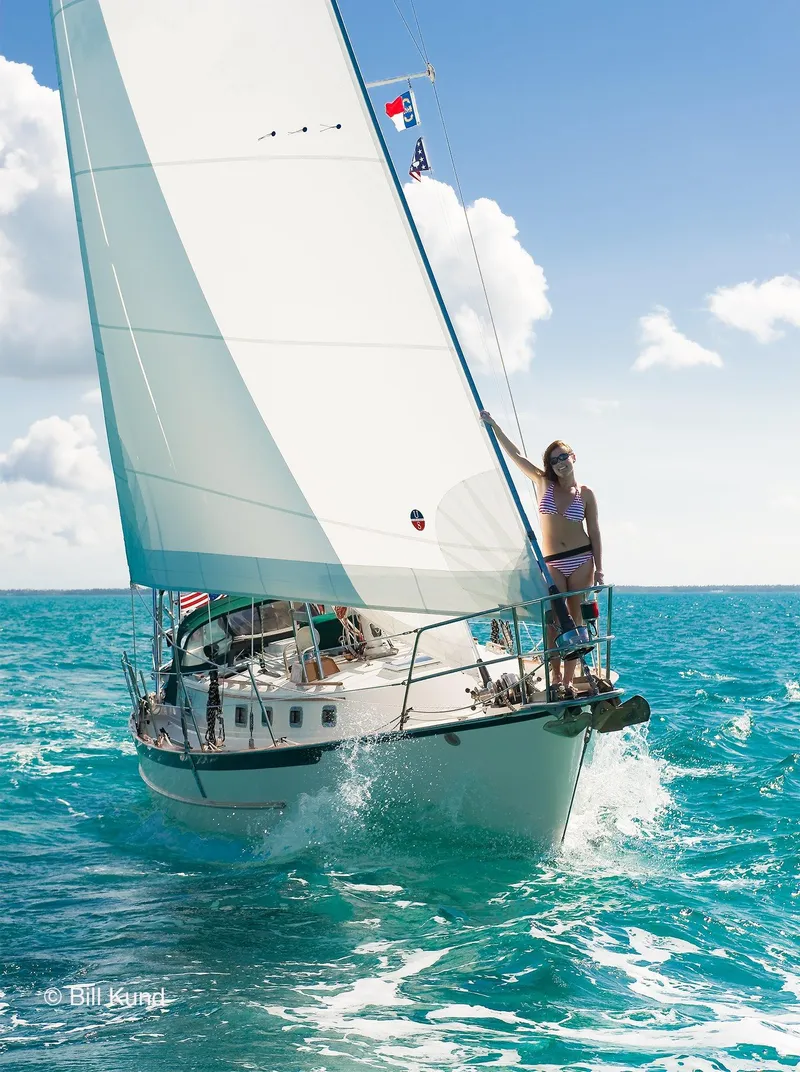 Slide: The Image of 2025 Pacific Seacraft 40 sailboat navigating clear turquoise waters under sunny skies. - 9