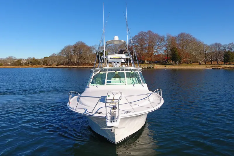 Slide: The Image of 2004 Cabo Express boat on calm water with clear blue sky. - 10