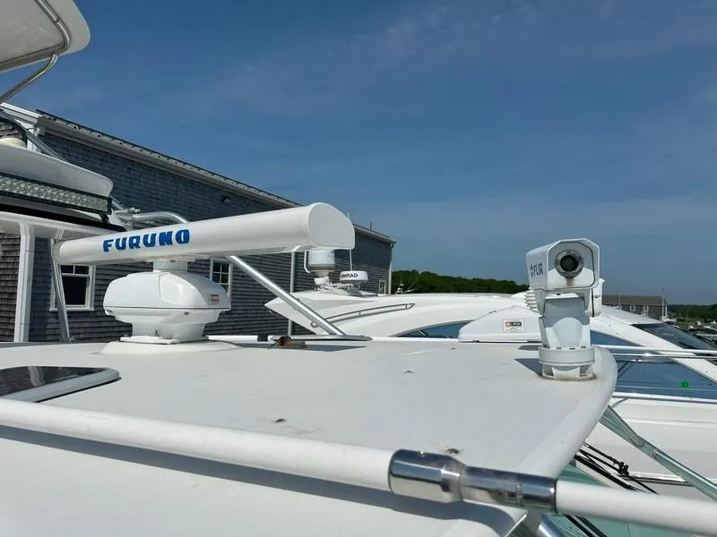 Slide: The Image of Radar and camera equipment on a 2004 Cabo Express boat under clear blue skies. - 18